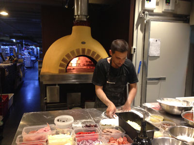 Mauto making pizza with the new pizza oven
